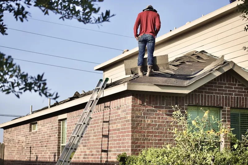 Professional roofer working on a residential roof in Brickyard Road-Queensgate